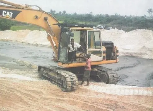 Tracked excavator working on a sand-filled site