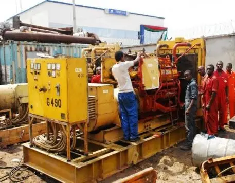 Engineers servicing a large industrial generator set