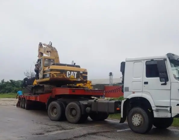 Excavator loaded on a low-bed trailer for haulage